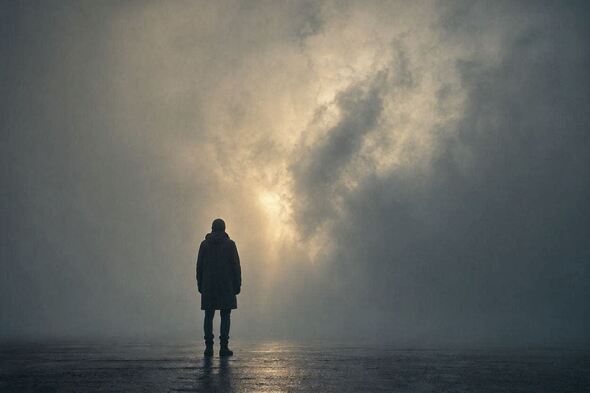 Silhouette of a person facing a foggy barrier with golden light breaking through, symbolizing clarity, identity shift, and confronting the myth of motivation.