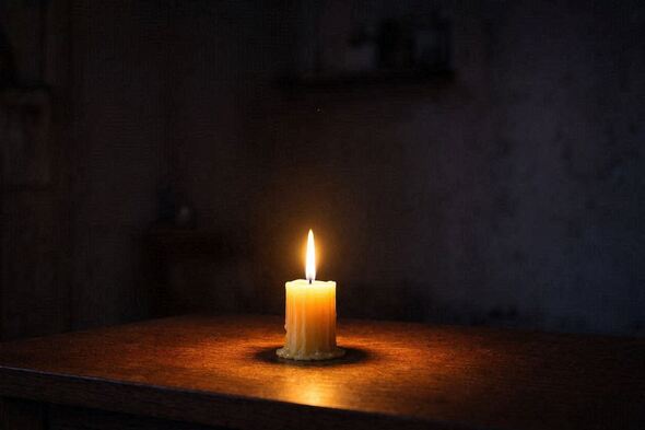 Single candle glowing in darkness, symbolizing emotional tone and subconscious recognition.